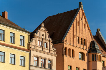 Historic European buildings with ornate architectural details against blue sky, historic cityscapes with decorative windows and intricate carvings. European cultural heritage and architecture