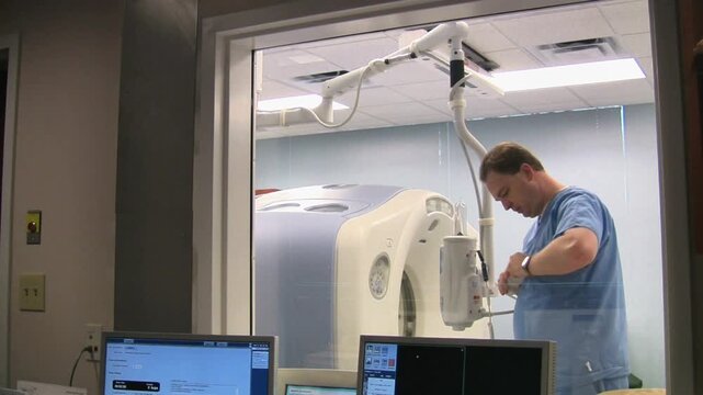 Radiology Technologist Preparing Power Injector for PET CT Scan Procedure