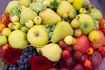 Summery arrangement of fruits and flowers