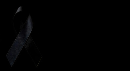 Elegant black ribbon symbolizing grief, remembrance, and support for a cause, a somber yet powerful symbol