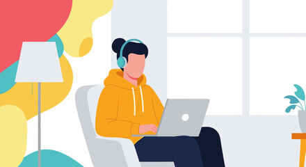 Young person in a cozy modern home using laptop and headphones, ideal for remote work, online education, or digital living concepts.