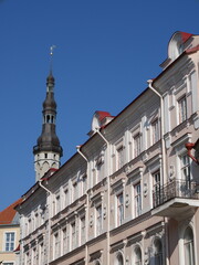 Fototapeta premium Beautiful picture of the tower of Tallin's old Town Hall and the geometry of the streets of Tallinn. Taken during a lovely summer day.