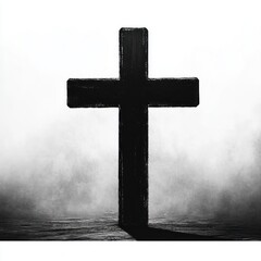 A black cross standing alone casting a shadow on a textured surface with a misty, gradient gray and white background evoking solemnity and contemplation