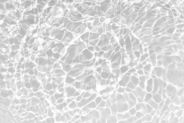 White water with ripples on the surface. Defocus blurred transparent white colored clear calm water surface texture with splashes and bubbles. Water waves with shining pattern texture background.