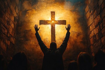 Person with raised hands worshiping or praying before a glowing cross on a textured wall in a dimly lit stone room with other shadowed figures present