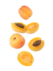 Fresh juicy apricots in air against white background