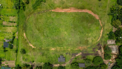 Aerial view of football field with dirt running track in the countryside area of Chiang Rai...
