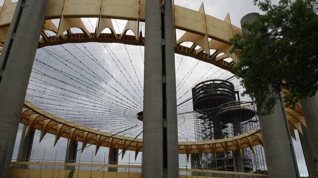 view of abandoned world's fair site in flushing corona meadows park in queens new york city (ufo shaped parachute jump and pavilion steel yellow) iconic landmark