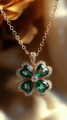 close-up of a delicate gold necklace pendant shaped like a four-leaf clover with green heart-shaped gemstones and small clear stones, elegant and sparkling jewelry
