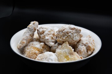 A Bowl of Powdered Sugar Beignets.