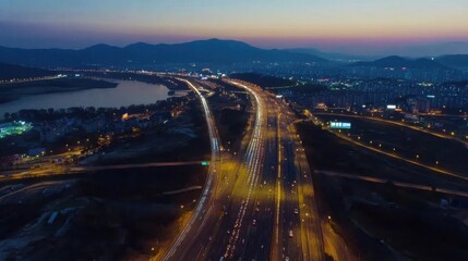Fototapeta premium Night Highway Overlooks Cityscape.