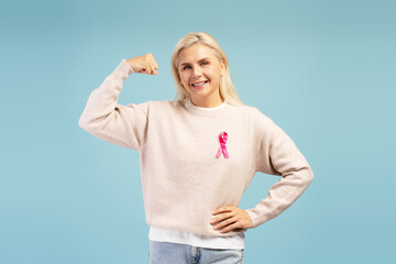 Fototapeta premium Woman showing strength and support for breast cancer awareness