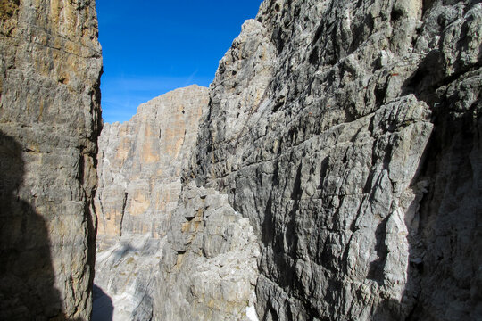 Via delle Bocchette Alte Via ferrata route in the Dolomiti di Brenta Alps in Italy. Equipped with bridge and steel cable and ladder hiking and climbing path in the high rocky mountains in Dolomites