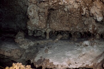 Close-up view of intricate rock formations inside a dark cave.
