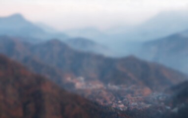 Fototapeta premium Blurry mountains and valley at dusk