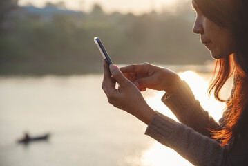 Woman hands holding mobile phone outdoor surfing internet online technology lifestyle. Close up woman hand using smartphone gadget text message focus on blank smart phone screen. Technology lifestyle