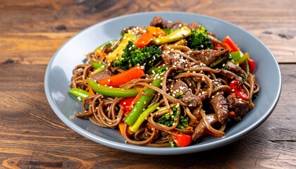 delicious spicy asian food soba with buckwheat noodles, beef, vegetables 