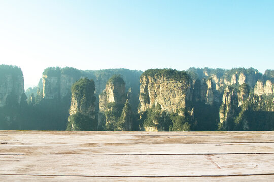 Empty brown wooden floor or table with landscape Zhangjiajie National Forest Park, China Natural quartz sandstone pillar. Hallelujah Mountain among woods and rocks in Tianzi Hunan Province.