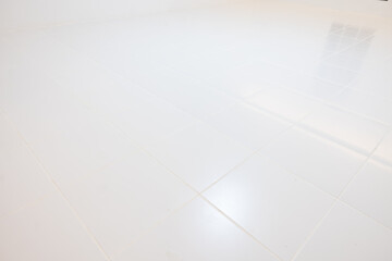 Interior floor decorative surface with white ceramic tile. Square pattern in perspective view at night. Reflection with warm white light. Graphic resource element suit for product display background.
