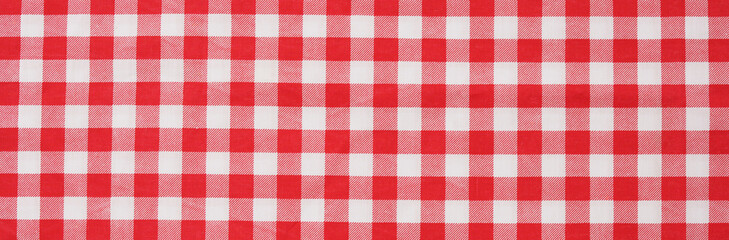 Closeup of a red and white checkered napkin or tablecloth texture. picnic cloth crumpled. Food decor element. Kitchen accessories. Top view background.