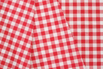 Closeup of a red and white checkered napkin or tablecloth texture. picnic cloth crumpled. Food decor element. Kitchen accessories. Top view background.