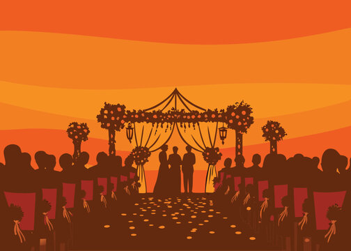 Romantic wedding ceremony with silhouetted couple, guests, and floral decorations at sunset