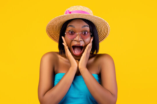 Excited young black woman in stylish summer outfit touching her face and shouting WOW on orange studio background. African American lady cannot believe huge summer sale, promo, discount - Powered by Adobe