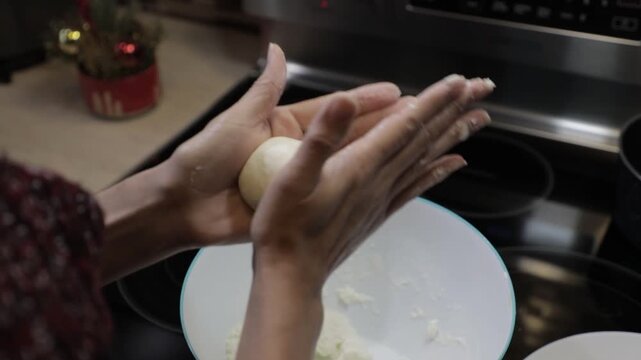 Woman preparing bunuelo dough for Christmas in Latin America