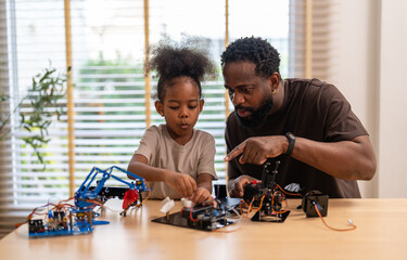 African father and daughter playing with stem robot kit, stem toys for kids fun learning and creativity at home, coding and building robots educational play activities, engineering skills development