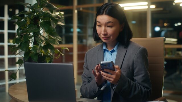 Asian Korean business woman businesswoman holding mobile phone showing smartphone green screen chroma key display Chinese Japanese female girl smiling thumb up advertise app recommend office workplace - Powered by Adobe