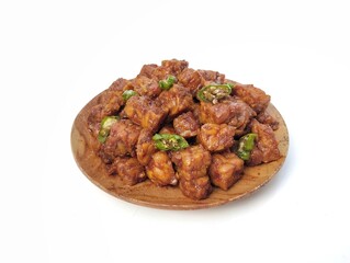 Oreg tempe or Indonesian food made from tempeh with soy sauce and spices on plate isolated on white background, High angle view 