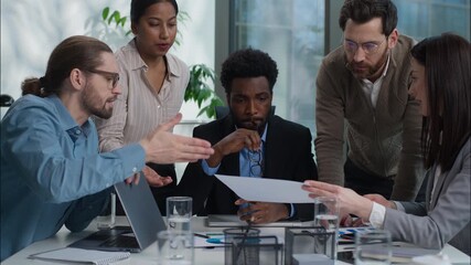 Business team multiracial group talking discussion graph chart document report analyzing men women in office coworkers African American Indian Caucasian businesswomen businessmen solve plan strategy