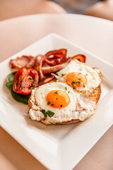 Fried Eggs & Bacon On Toast With Tomato