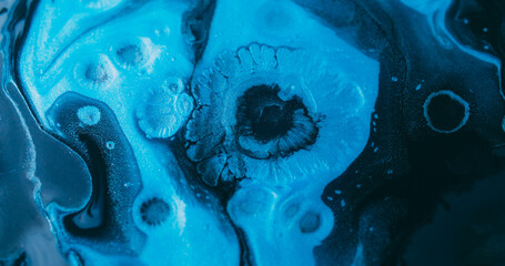 Ink splatter. Fluid spill. Defocused blue color chemical drop dark black texture floating on...