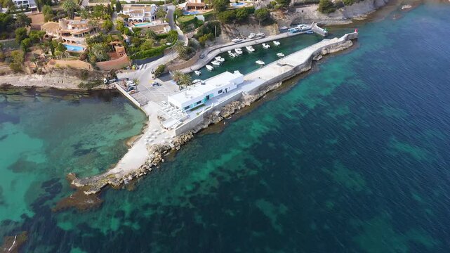 Aerial view of the little port of Les Bassetes and his rocky coast in Benissa, Mediterranean Sea, Spain.
