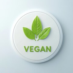White disc with green leaves and the word vegan.