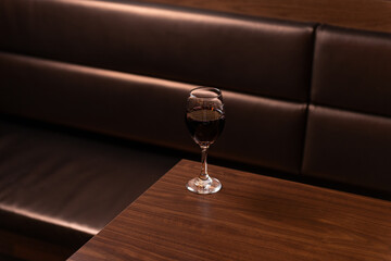 Glass of red wine on table