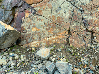 rocks wall in a granite quarry. colorful natural textured background. closeup view.