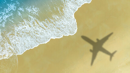 Aerial view of shadow passenger plane silhouette and sandy beach blue sea with waves at sea beach summer vacation sea travel concept	