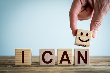 Empowering Affirmation I Can with Smiling Face Block on Wooden Surface against Light Blue Background Inspiring Positive Thinking and Self Belief