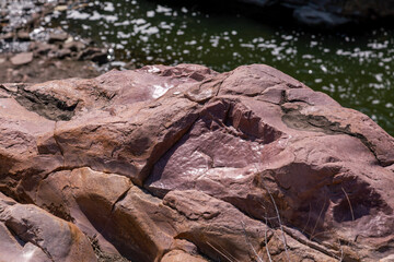 Naturally Polished Smooth Texture Sioux Quartzite Red Rocks at Falls Park near River