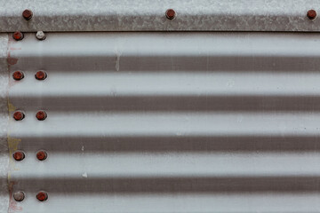 Corrugated Steel Grain Bin Texture with Rusted Metal Bolts Close Up