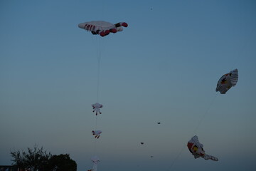 Large cartoon jellyfish kite floating in the sunset sky