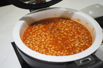 Cooking beans in a rich tomato sauce at home kitchen