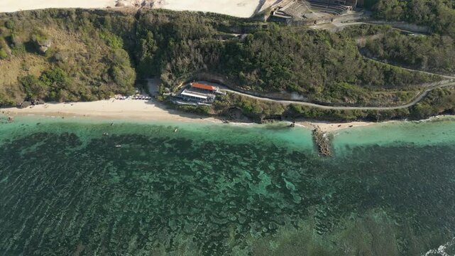 Secluded Beach At Bottom Of Uluwatu Cliffs Looks Out Over Blue Lagoon Drone Track Left 4K 60FPS