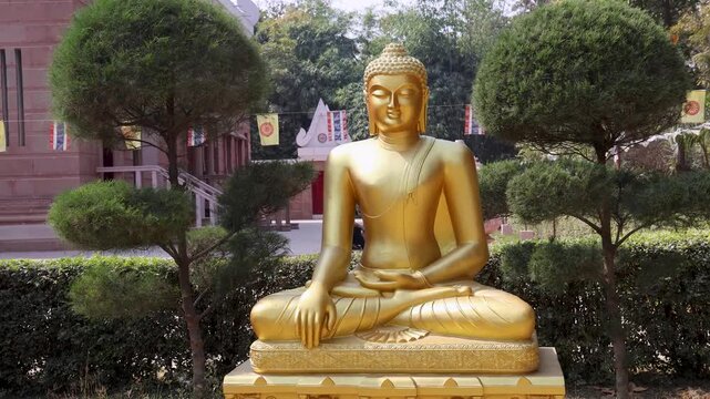 golden buddha idol sitting in peaceful lotus position at outdoor