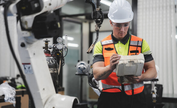 Smart Caucasian engineer work setup AI automated in robotics electronics engineering laboratory. Technician inspector maintenance repair check robot arm machine in artificial intelligent laboratory.