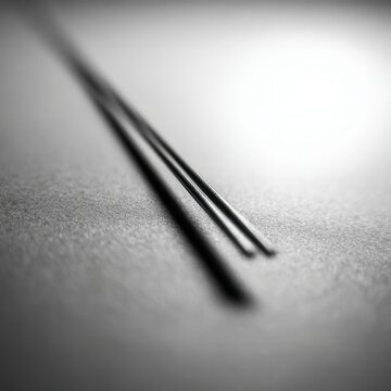 Two parallel, thin, dark lines on a light surface