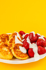 Delicious pancakes with fresh strawberries and cream topping