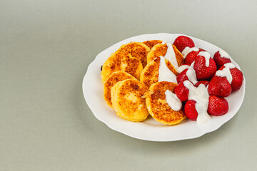 Delicious pancakes served with strawberries and cream